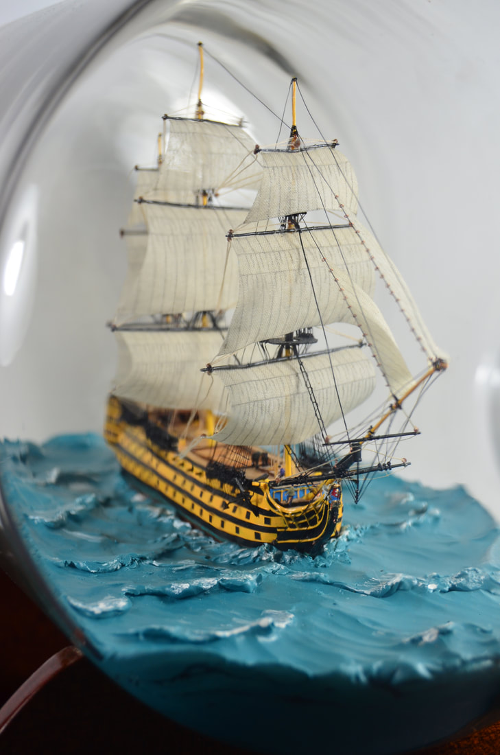 Miniature model in a bottle of the HMS Victory under full sail 