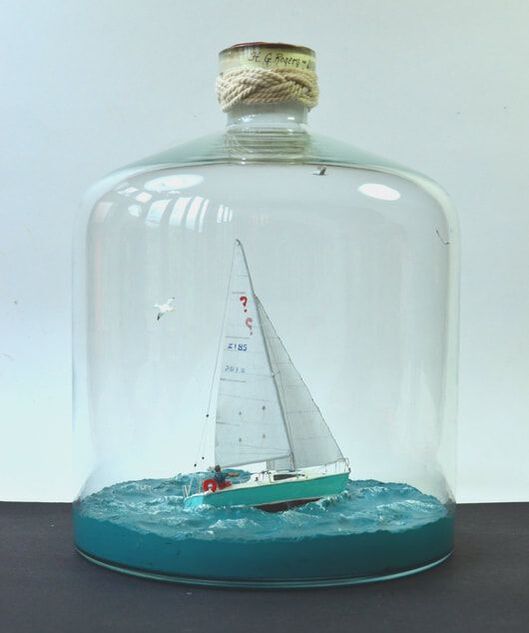 Ship in a vertically oriented bottle of a single-masted sailboat
