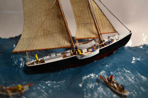 Miniature diorama in a bottle of the Schooner Adventure and her crew in fishing dories.
