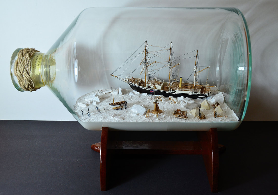 Diorama in a bottle of Shackleton's ship Endurance trapped in the pack ice while his men set up camp and struggle to survive